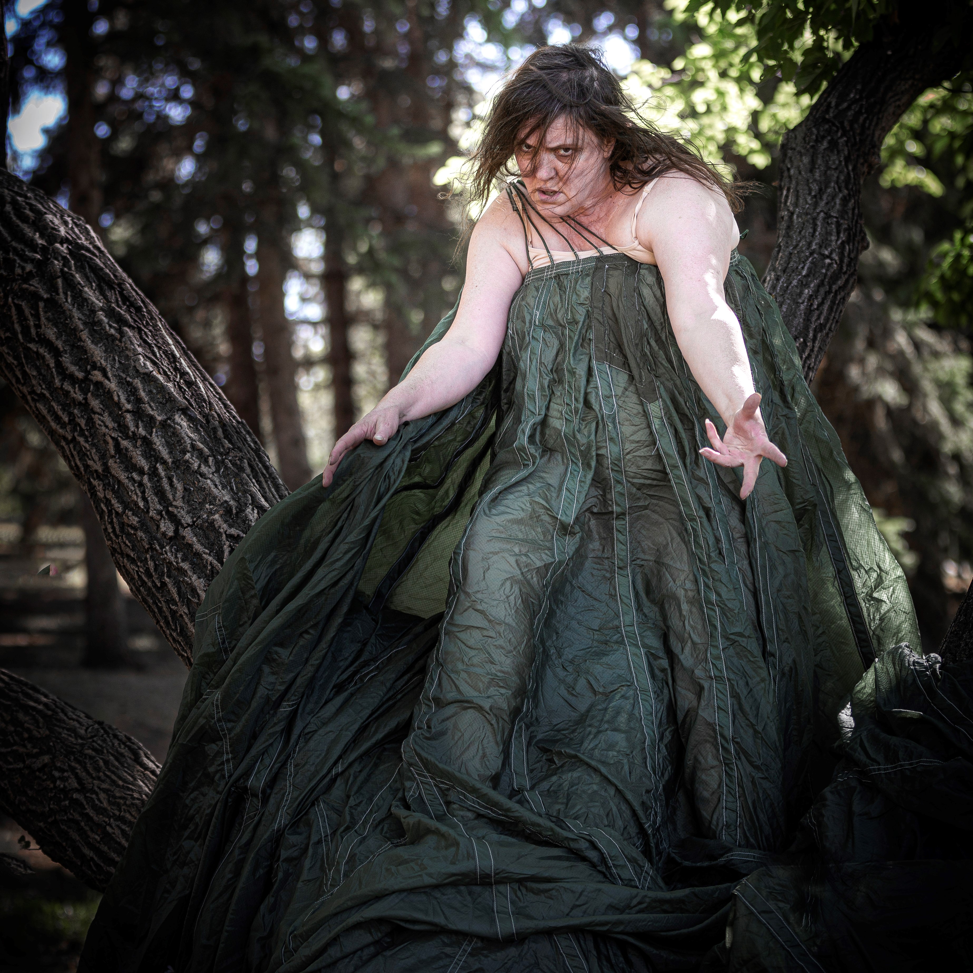 Jackie Latendresse - Photo of dance artists wrapped in a long green dress dancing.