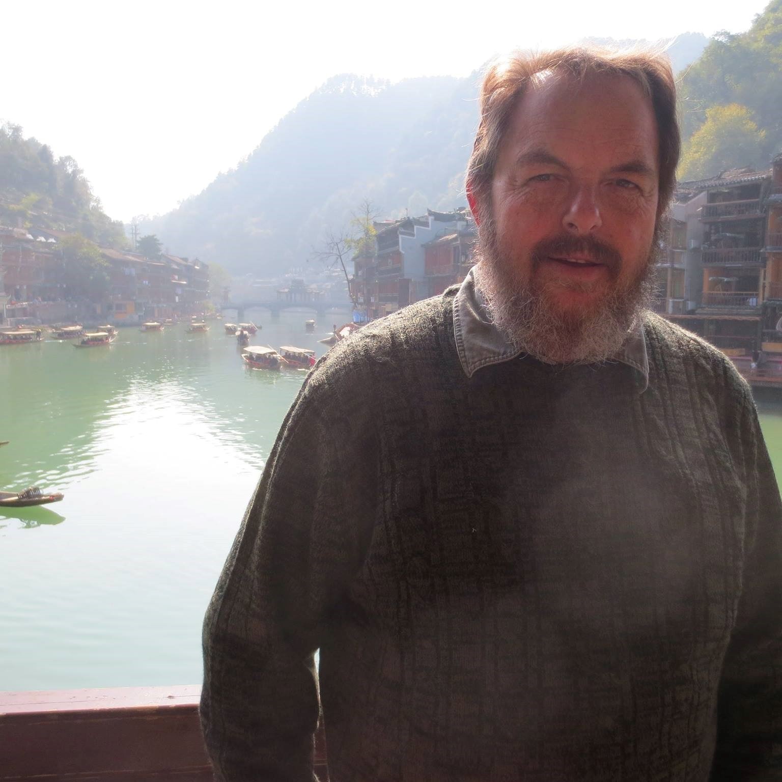 Kim Houghtaling - Older white man standing in front of lake.