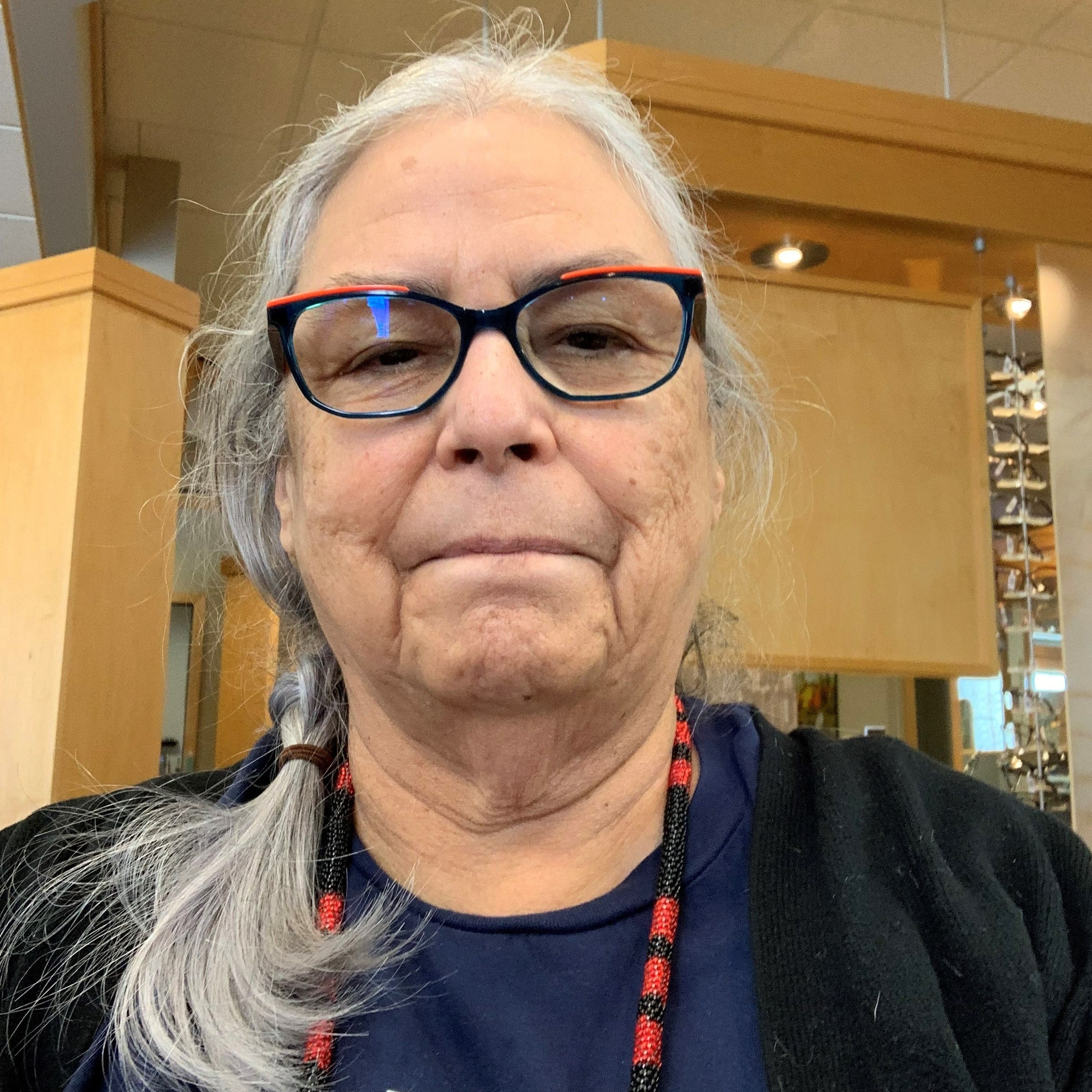 Ruth Cuthand - Indigenous woman wearing glasses and gray hair.
