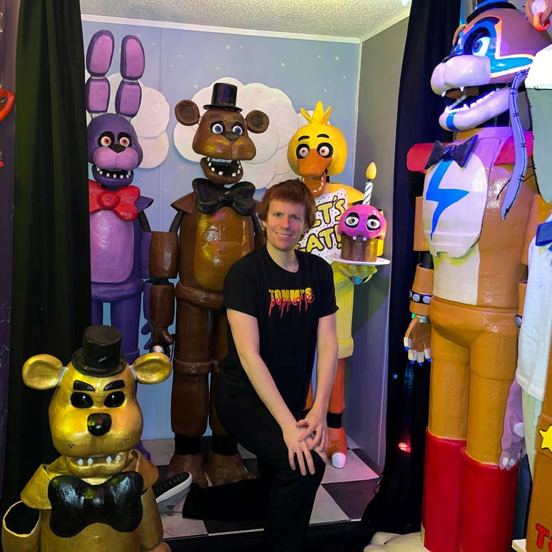 Tommy Kirk Five Nights at Freddys Puppets - A man standing in a room full of life size puppets.