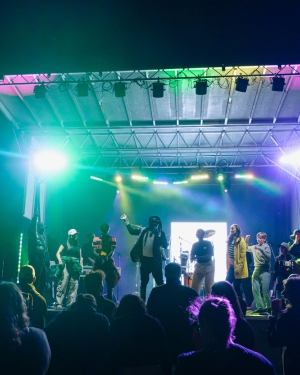 A STAGE SHOT OF A CONCERT WITH GREEN AND OTHER COLOURFUL NEON LIGHTSS - CCF