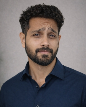 Portrait of man with short dark hair, mustache and beard wearing navy blue shirt - John THIMOTHY
