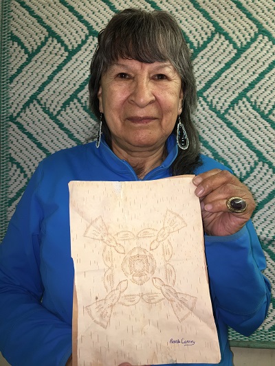 SKArts - Rosella Carney with one of her birch bark bitings.