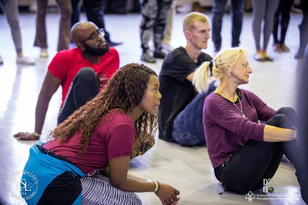 SKArts - Flany Ba sitting with her students.