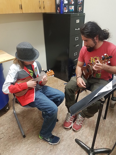 SKArts - Felipe Gomez teaches a student how to play ukulele in a private lesson.