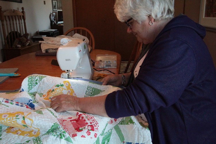 SKArts - Sandra Dixon sewing a colorful quilt. 