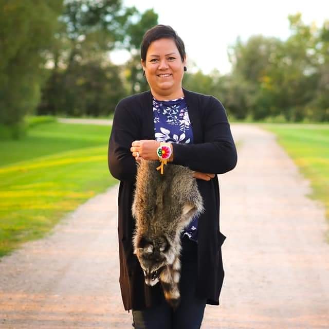 Marcy Friesen holding an animal pelt