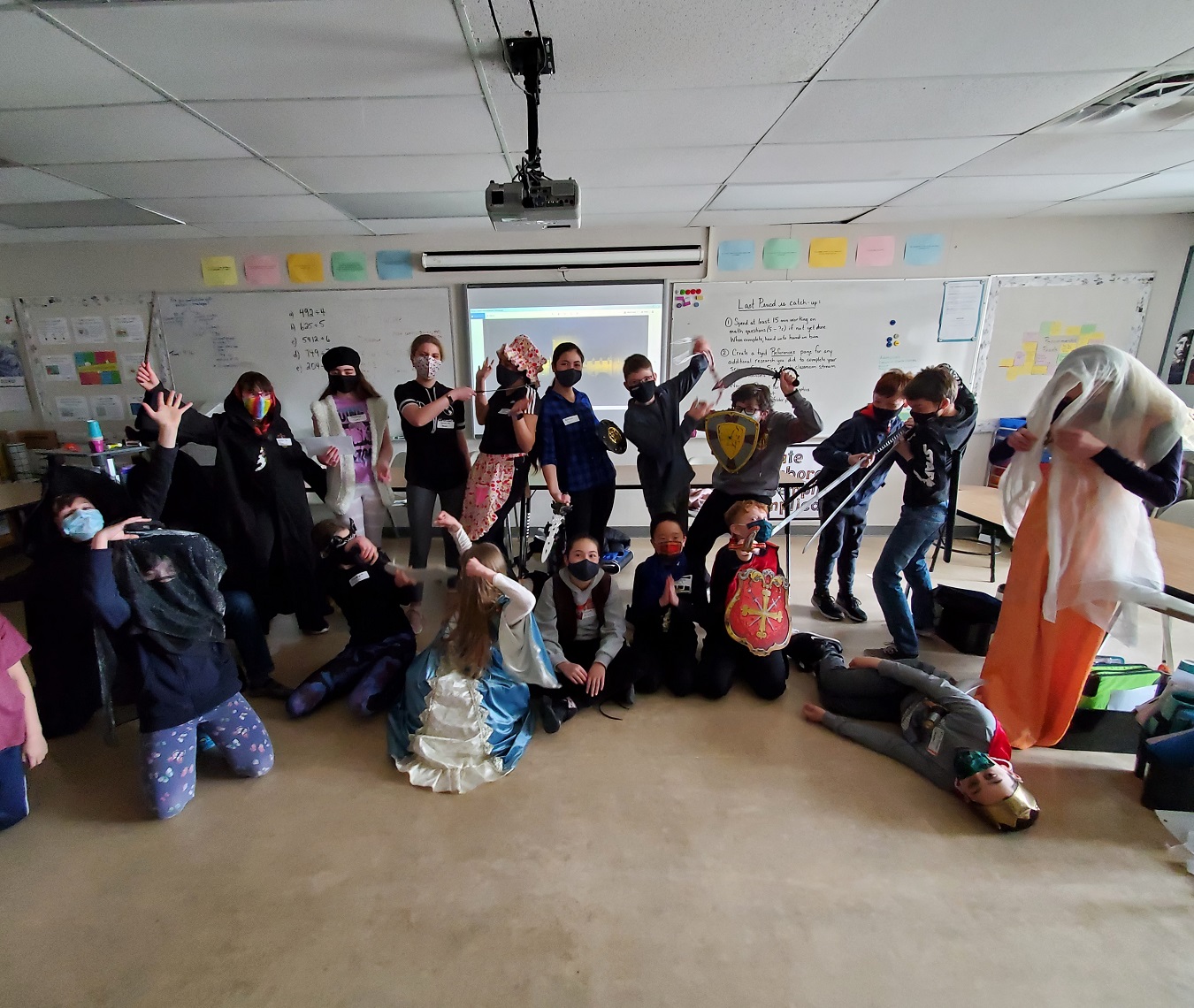 A group of students dressed in costumes act out a scene from a Shakespeare play.