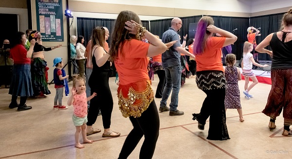 A group of people bellydancing at a workshop at the festival.