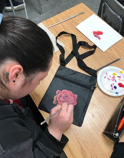 A Turtleford Transition School student works on a purse design